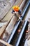 Installation of water supply main pipes. A worker in a helmet connects the pipes in a technological ditch. Vertical photo