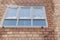 Installation of a window in a brick building. Industrial engineering. Darkening and installation of a window opening using