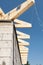 Installation of wooden beams, roof rafters at roof construction. New house made with autoclaved aerated concrete blocks.