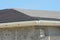 Installing asphalt shingles. Roof repair with unfinished rain gu