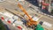 Installing concrete plates by crane at road construction site timelapse.