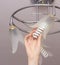 Installing an energy-saving modern spiral bulb in a chandelier suspended from the ceiling, close-up, arm, saving, hand