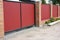 Installing house red metal fence with garage gate of modern style design