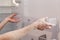 Installing new, clean shelves in an empty washed refrigerator. Young woman cleaning refrigerator