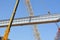 Installing the steel bars of a new traffic bridge for cars and vehicles in their places with cranes