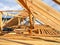 Installing wooden beams, logs, timber, rafters, trusses for house attic construction. Roofing construction.