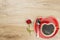 Instant coffee in a cup on a wooden table with a rose.