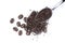 Instant granulated coffee with roasted coffee beans in stainless teaspoon