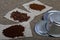 Instant, ground coffee and coffee beans. Details of a Vietnamese coffee maker. Against the background of coarse linen fabric.