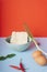 Instant noodle and chopstick with Tom Yum ingredients and eggs over blue background