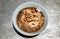 Instant noodles in braised pork soup with pork balls and fatty pork rinds in white bowl