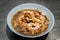 Instant noodles in braised pork soup with pork balls and fatty pork rinds in white bowl