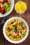 Instant noodles in white bowl on wooden table background and vegetables salad