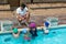 Instructor advising little swimmers at poolside