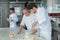 Instructor and apprentices in bakery making pretzels