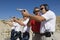 Instructor Assisting Officers With Hand Guns At Firing Range