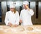 Instructor and baker apprentice kneading bread dough