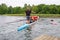 Instructor coach teaching a tourists how the eight rowing boat works in the waters of Galve lake. Eight is a rowing boat used in