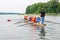 Instructor coach teaching a tourists how the eight rowing boat works in the waters of Galve lake. Eight is a rowing boat used in