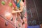 Instructor guiding woman on rock climbing wall