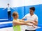 Instructor holding training with woman in trampoline room