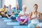 Instructor performing yoga with seniors