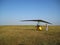 The instructor pilot and passenger sit in a hang glider