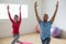 Instructor with student practicing warrior 1 pose in yoga studio