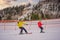 Instructor teaches boy skier to use on ski lift