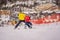 Instructor teaches boy skier to use on ski lift