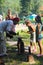 Instructor teaches the girl blacksmithing on the festival of blacksmiths