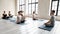 Instructor teaching diverse people, doing Padmasana exercise, practicing yoga