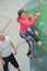 instructor watching woman climb indoor structure