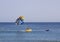 Instructors prepare their customer for a paragliding experience from the back of their boat at the beach in Albuferia