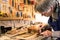 Instrument maker masking a guitar with tape