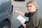 Insurance agent, middle-aged woman, conducts pre-insurance inspection of car