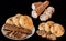 Integral Brown Baguette with Leavened Flatbread Loaves Isolated on Black Background