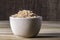 Integral rice on glass bowl isolated on wooden table