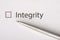 Integrity - checkbox with a tick on white paper with metal pen. Checklist concept