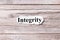 Integrity of the word on paper. concept. Words of Integrity on a wooden background