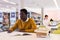 Intelligent african-american male student engaged in research working with books in university library