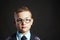 Intelligent child in glasses near school desk