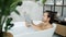 Intelligent man reading book lying in bathtub relaxing in warm water with foam in light bathroom