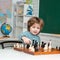 Intelligent, smart ass kids. Games good for brain intelligence concept. Kids chess school. Chess, success and winning.