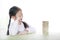 Intend little Asian child girl thinking to playing wood blocks tower game for Brain and Physical development skill in a classroom