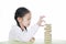 Intend little Asian child girl thinking to playing wood blocks tower game for Brain and Physical development skill in a classroom