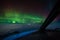 Intense beautiful Northern Lights, Aurora Borealis seen from cockpit