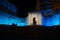 An intense blue light illuminates Porta Livorno in the night