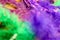 Intense color -Mardi Gras - Carnaval background in purple and green - blurred feathers and a mask on gold background