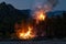 Intense flames from a massive forest fire at night